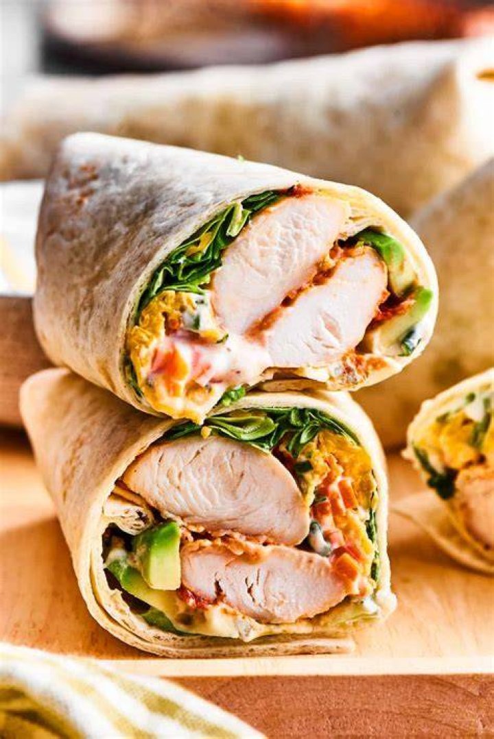 a chicken wrap on a white background