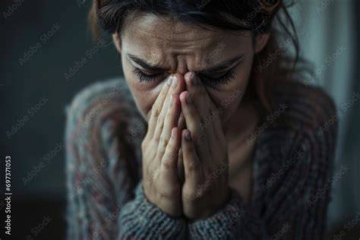 A depressed woman has trouble falling asleep and lies in her bed wide awake | Source: Shutterstock