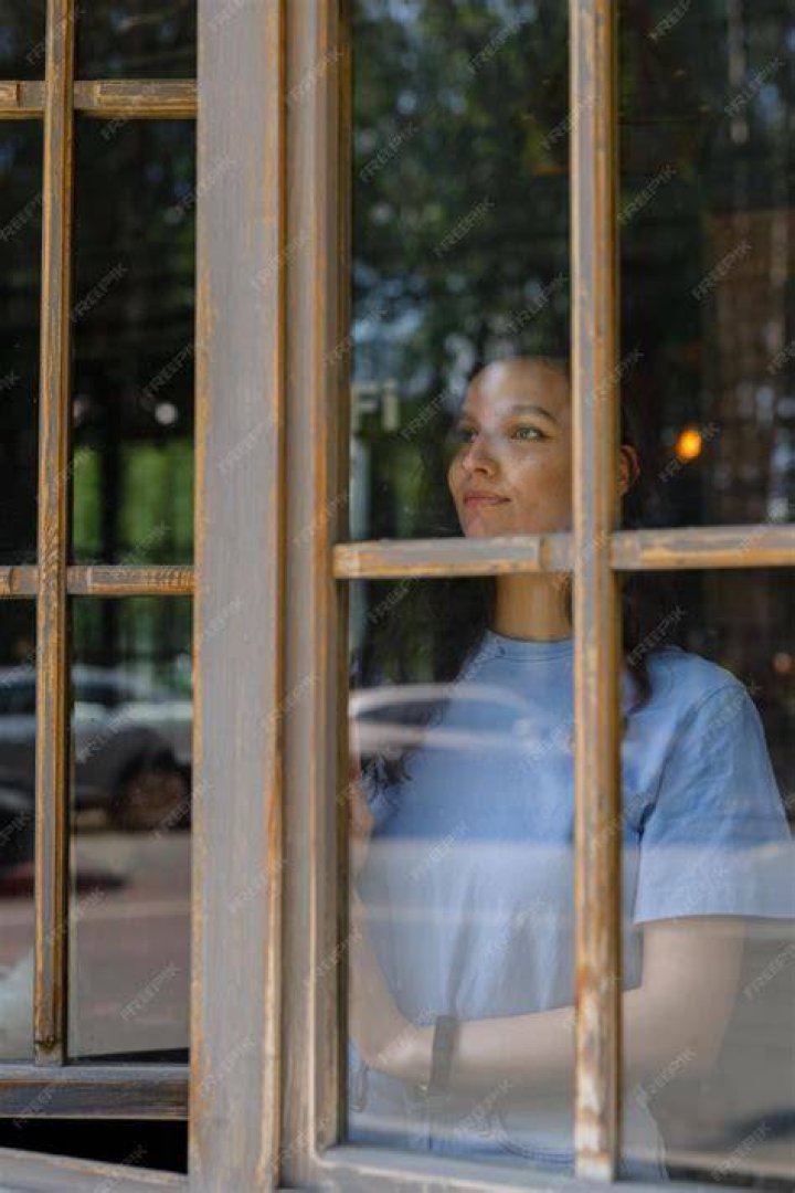 A woman looking outside a window. | Source: Unsplash
