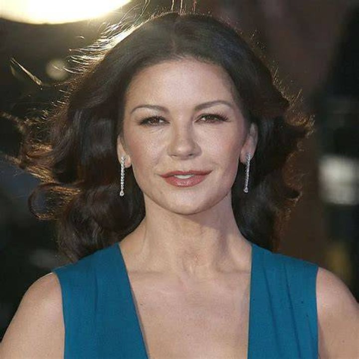 Actress Catherine Zeta-Jones (R) arrives with her husband, actor Michael Douglas and their children Dylan and Carys Douglas, to attend a Royal Investiture at Buckingham Palace on February 24, 2011 in London, England. | Source: Getty Images
