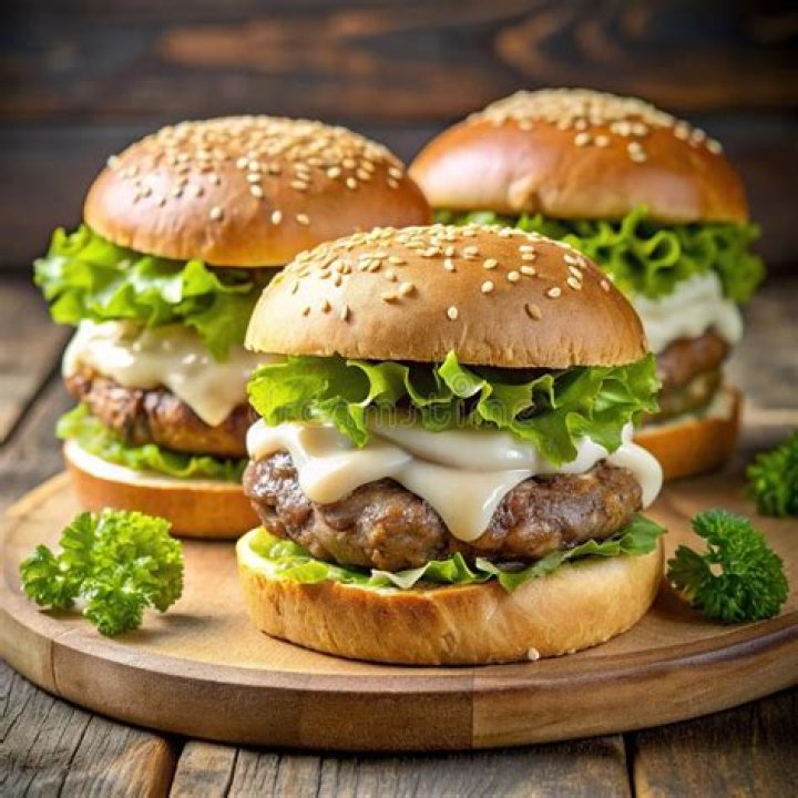Both burgers have beef, cheese, pickles, onion, mustard and tomato sauce