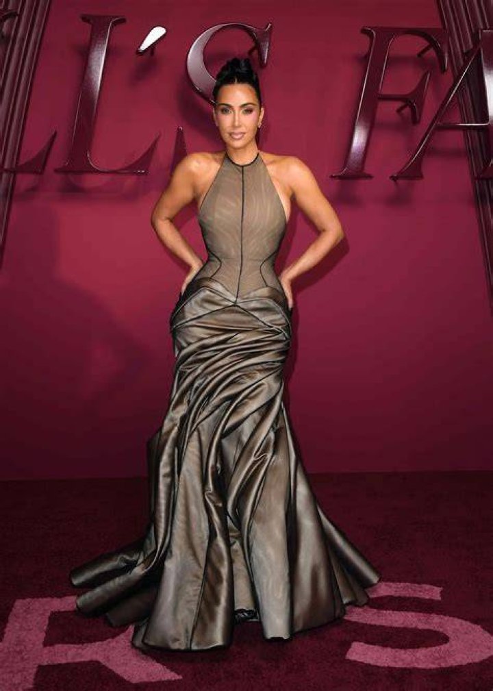 Kim Kardashian wears a nude sequined gown and Pete Davidson is dressed in a black suit as they look at each other at the 2022 Met Gala