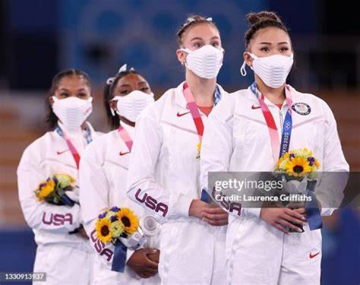 Lee, Biles, Chiles, and McCallum all wore matching black and rose gold leotards inspired by the Tokyo 2020 torch. GK said have a 'dynasty' theme