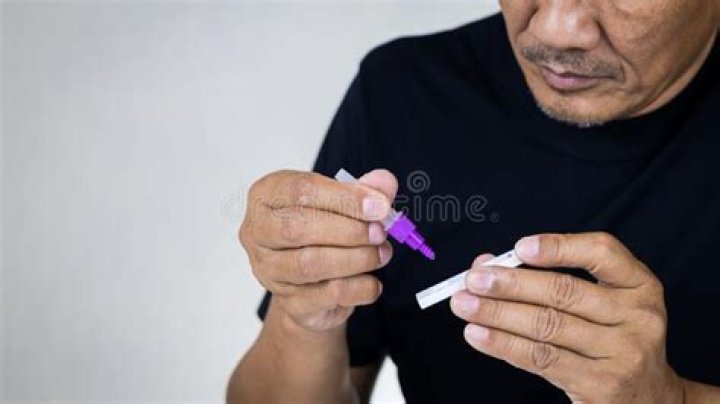 Man self tests for COVID-19 home test kit.