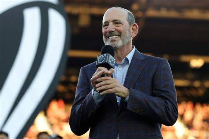 MLS Commissioner Don Garber (left) with Apple's Tim Cook (middle) and Eddy Cue (right)