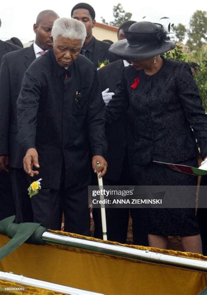 Nelson Mandela, accompanied by his wife Winnie, raises his hand in celebration as he walks out of the Victor Verster prison, near Cape Town, on February 11, 1990, after spending 27 years in apartheid jails