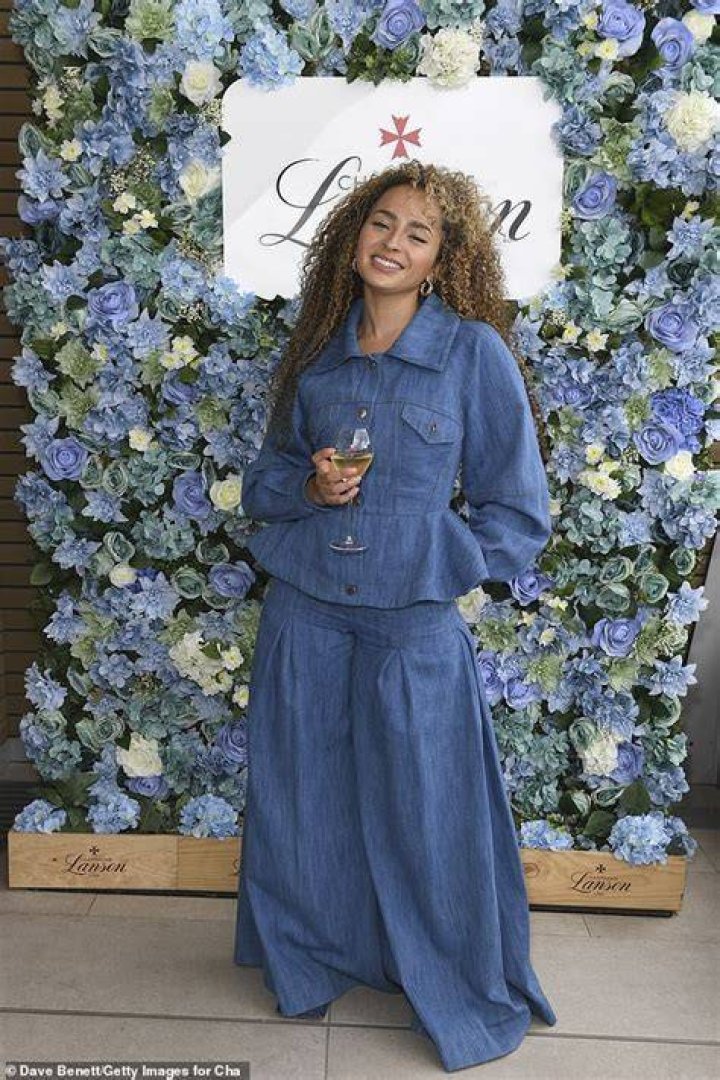 Style: Ella looked effortlessly chic in a shiny black suit and cream silk shirt as she left the party after previously posing with her famous father on the red carpet