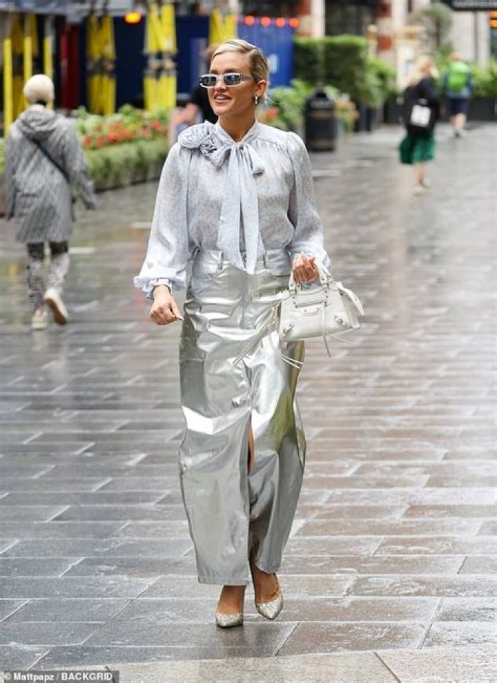 Style: She completed the chic ensemble with suede navy heels and wore a retro pink hair net over her brunette tresses