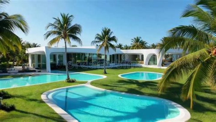The villa boasts three pools, a gym and sauna and borders the golf course where flames are now closing in