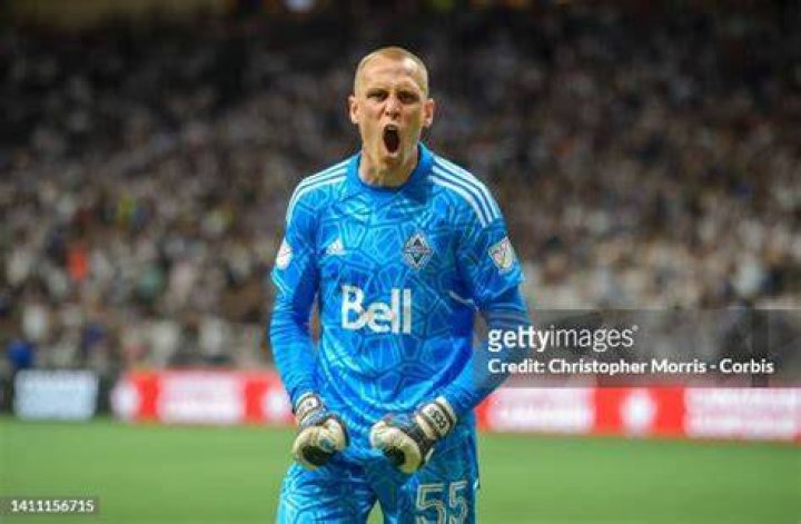 Vancouver Whitecaps goalkeeper Cody Cropper (55) grabs the ball above Real Salt Lake's Sergio Cordova, second from left, and Justen Glad (15) during the second half of an MLS soccer match in Vancouver on June 4