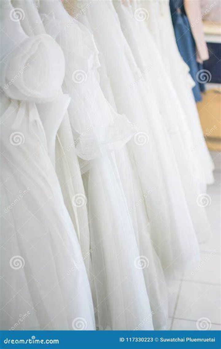 White dresses hanging on a stand | Source: Unsplash